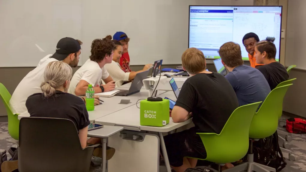 Students collaborating together at table in the TILL Classroom