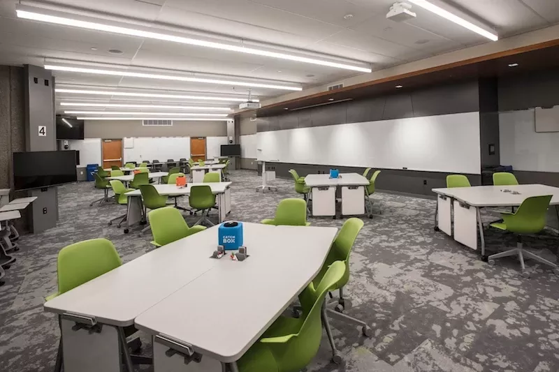 TILL Classroom with tables and green chairs
