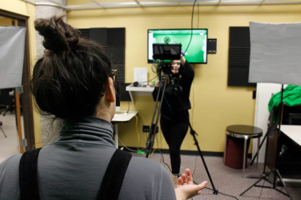 Student recording someone with video camera.