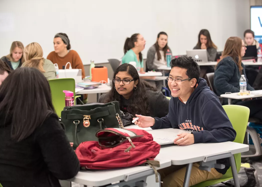 Group of students around a table working on a project.