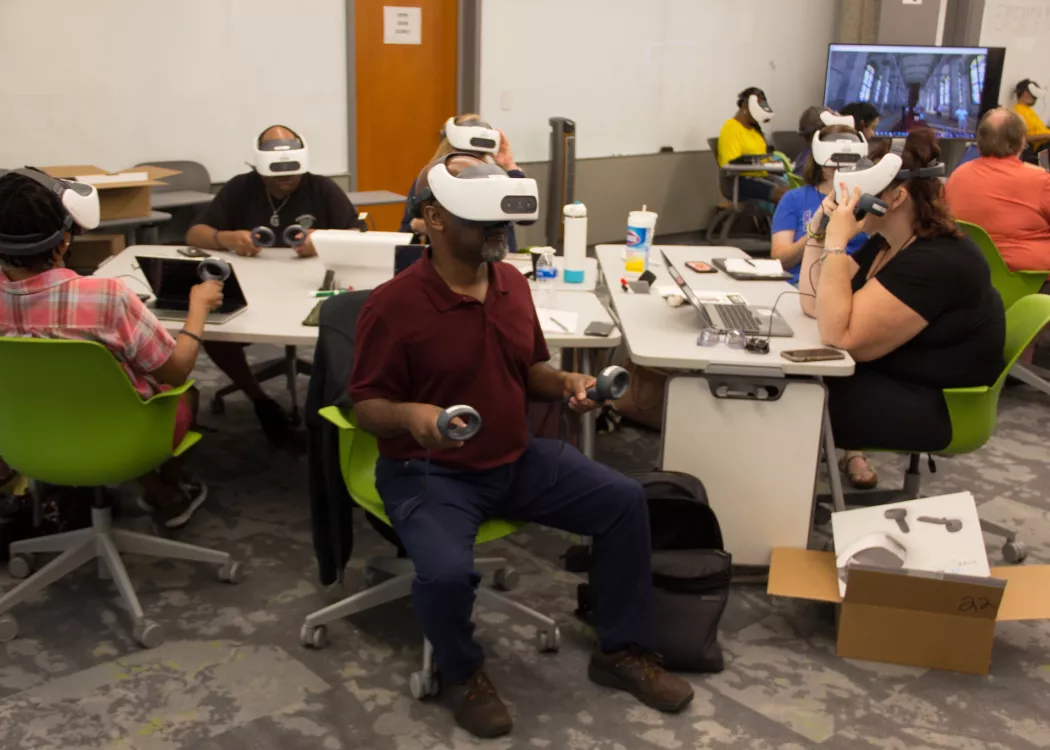 TILL staff member examining newly acquired VR headsets