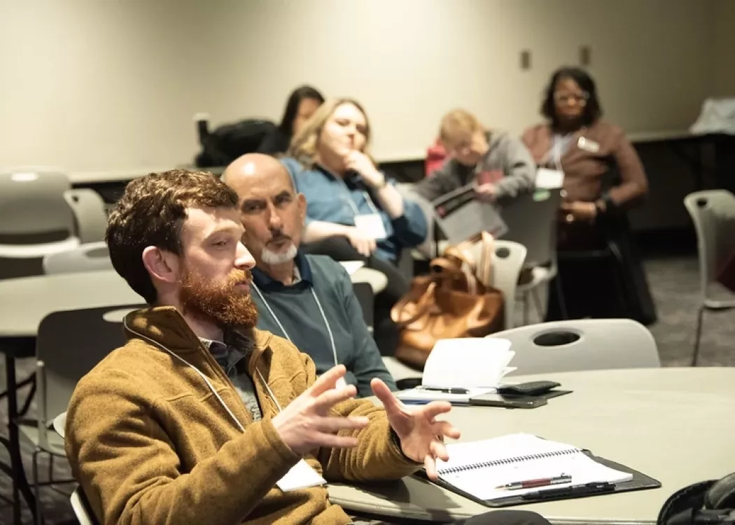 Participant discussing within a concurrent session at conference.