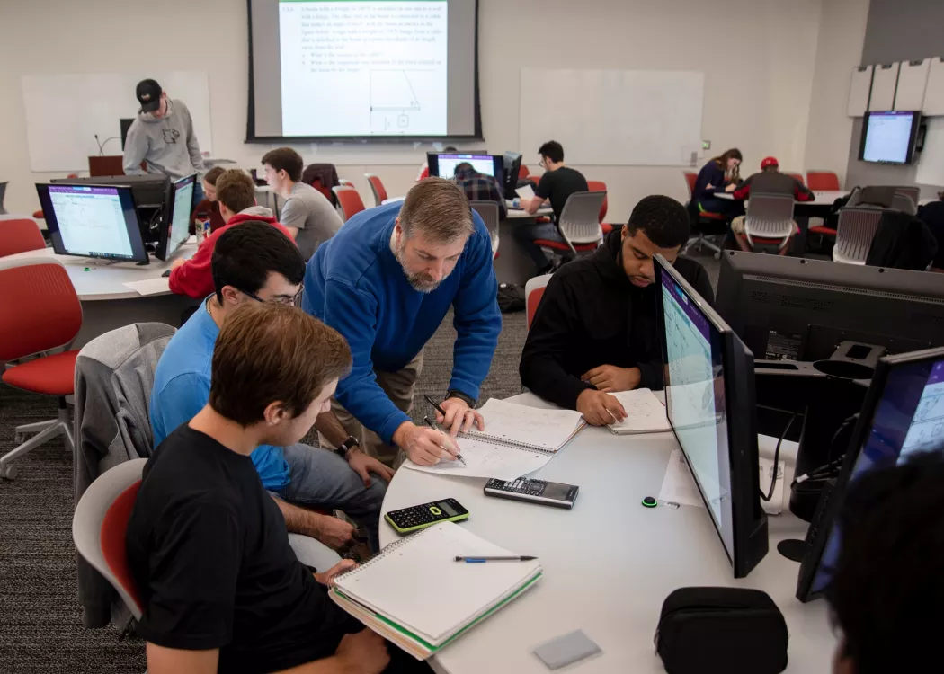 Professor helps students solve problems