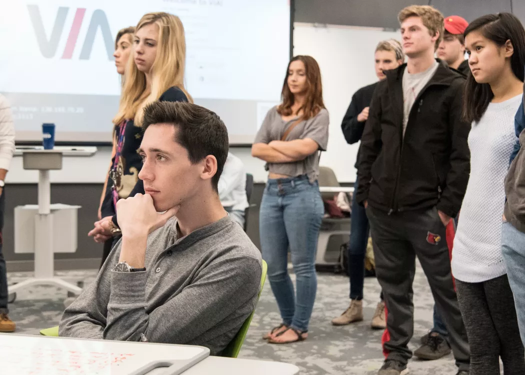 Group of students looking in one direction, listening.