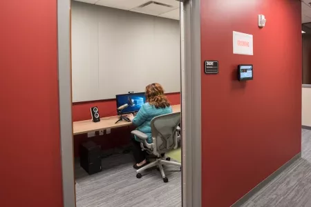 TILL recording studio with a woman working on computer inside
