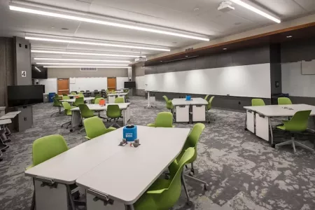 TILL Classroom with tables and green chairs